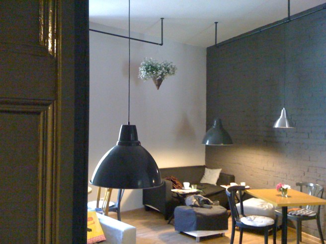 Exposed walls, Café tables, chairs, low ceiling lamps