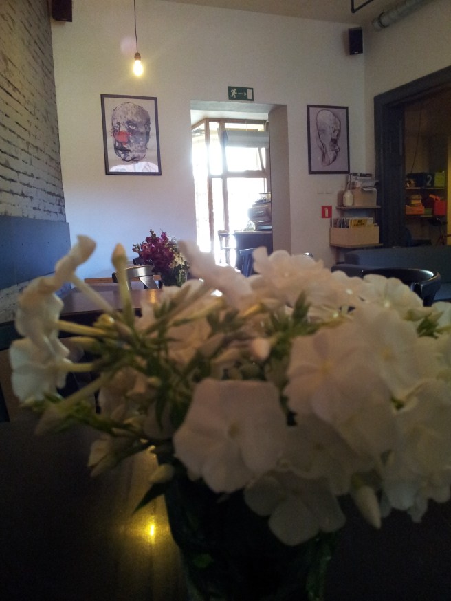 View of a café room and a table with flowers. 